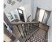 Elegant foyer showcasing a staircase with rod iron details, hardwood floors, and a view of the front door at 653 Gable Oaks Nw Ln, Concord, NC 28027