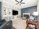 Comfortable living room with a fireplace, built-in shelving, stylish furniture, and a ceiling fan for optimal comfort at 653 Gable Oaks Nw Ln, Concord, NC 28027