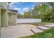 Backyard featuring a concrete patio, brick border, small step ups, and a white fence at 6707 Dunton St, Huntersville, NC 28078