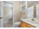 Neutral bathroom featuring a white toilet, vanity, and view into an adjacent carpeted bedroom at 6707 Dunton St, Huntersville, NC 28078