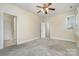 Bedroom with neutral carpet, ceiling fan, and two closets at 6707 Dunton St, Huntersville, NC 28078