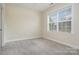 Bedroom with neutral carpet and a bright window at 6707 Dunton St, Huntersville, NC 28078