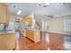 Open floor plan featuring a kitchen with an island, hardwood floors, and natural light at 6707 Dunton St, Huntersville, NC 28078