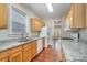 Modern kitchen with granite countertops, wood cabinets, and stainless steel appliances at 6707 Dunton St, Huntersville, NC 28078