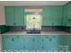 A stylish kitchen showcases its green cabinets, sleek countertops, and modern black hardware at 805 Mark Dr, Shelby, NC 28152