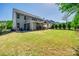 Large backyard featuring a covered patio, seating area, and lush green grass at 826 Coralbell Way, Fort Mill, SC 29708