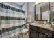 Bathroom with shower and tub combo, modern vanity with granite countertop, and a decorative mirror at 826 Coralbell Way, Fort Mill, SC 29708