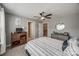 Comfortable bedroom features neutral paint and decor, a ceiling fan, and a dresser at 826 Coralbell Way, Fort Mill, SC 29708