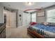 This bedroom features natural light, baseball themed bedding, and plush carpet at 826 Coralbell Way, Fort Mill, SC 29708