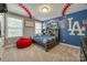 This bedroom showcases a baseball theme and includes a queen bed and ample natural light at 826 Coralbell Way, Fort Mill, SC 29708