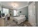 Bright bedroom with natural light, neutral walls, a chandelier, and a comfortable bed at 826 Coralbell Way, Fort Mill, SC 29708
