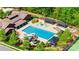 Aerial view of a neighborhood pool with a slide, splash pad, lounge chairs, and shaded seating areas at 826 Coralbell Way, Fort Mill, SC 29708