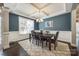 Elegant dining room with coffered ceiling, dark wood floors, and stylish chandelier at 826 Coralbell Way, Fort Mill, SC 29708