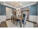 Open dining room featuring a large wooden table, coffered ceiling and view to additional rooms at 826 Coralbell Way, Fort Mill, SC 29708