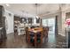 Open concept kitchen featuring dark cabinets, a center island, and a breakfast nook leading to a backyard deck at 826 Coralbell Way, Fort Mill, SC 29708