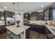 Kitchen with dark cabinetry, stainless steel appliances, granite counters and island with bar stool seating at 826 Coralbell Way, Fort Mill, SC 29708