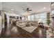 Bright living room featuring a large sectional couch, dark hardwood floors, and an open floor plan at 826 Coralbell Way, Fort Mill, SC 29708