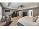 A view of the main bedroom with a tray ceiling, gray walls, carpet, and modern furniture at 826 Coralbell Way, Fort Mill, SC 29708