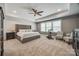 Spacious main bedroom featuring a tray ceiling, plush carpet, neutral decor, and an exercise bike at 826 Coralbell Way, Fort Mill, SC 29708