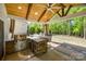 Outdoor kitchen with a built-in grill, bar seating, and a mini fridge, perfect for entertaining at 826 Coralbell Way, Fort Mill, SC 29708