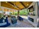 Covered patio featuring an outdoor fireplace, comfortable seating, a ceiling fan, and a view of the backyard at 826 Coralbell Way, Fort Mill, SC 29708