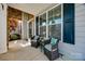 Cozy porch area with comfortable seating, decorative pillows, and a view of the landscaped yard at 826 Coralbell Way, Fort Mill, SC 29708