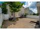 Backyard featuring a brick patio, privacy fence, and mature landscaping at 10102 Tolleson Ave, Charlotte, NC 28277