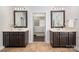 Bright bathroom featuring double vanity, framed mirrors, and a view into the spacious walk-in closet at 10102 Tolleson Ave, Charlotte, NC 28277