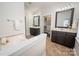 Primary bathroom with dual vanities, soaking tub, and walk-in closet at 10102 Tolleson Ave, Charlotte, NC 28277