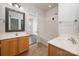 Bright bathroom featuring double vanity, framed mirror, and a view into the adjacent tub at 10102 Tolleson Ave, Charlotte, NC 28277