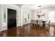 Open-concept dining area with hardwood floors next to the front door at 10102 Tolleson Ave, Charlotte, NC 28277