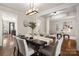 Elegant dining room with stylish light fixture and hardwood floors at 10102 Tolleson Ave, Charlotte, NC 28277