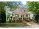 Charming two-story home with a inviting front porch and manicured landscaping at 10102 Tolleson Ave, Charlotte, NC 28277