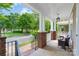 Inviting front porch featuring brick columns, white railings, and comfortable seating at 10102 Tolleson Ave, Charlotte, NC 28277