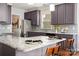 Eat-in kitchen with granite island, grey cabinets, and stainless steel refrigerator at 10102 Tolleson Ave, Charlotte, NC 28277