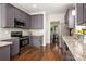 Well-equipped kitchen with grey cabinets, stainless steel appliances, and ample counter space at 10102 Tolleson Ave, Charlotte, NC 28277