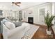 Cozy living room with fireplace, ceiling fan, and view to the kitchen and dining area at 10102 Tolleson Ave, Charlotte, NC 28277