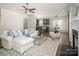 Spacious living room with kitchen and dining area, fireplace, ceiling fan, and ample natural light at 10102 Tolleson Ave, Charlotte, NC 28277