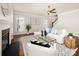 Bright living room features a fireplace, ceiling fan, and modern decor with white furniture at 10102 Tolleson Ave, Charlotte, NC 28277