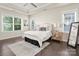 Bright main bedroom with tray ceiling, natural light, and comfortable bed at 10102 Tolleson Ave, Charlotte, NC 28277