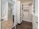 Large walk-in closet and ensuite bathroom featuring a soaking tub and a glass door shower at 10102 Tolleson Ave, Charlotte, NC 28277