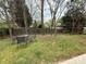 Fenced backyard featuring a patio seating area and a grassy yard shaded by mature trees, perfect for outdoor enjoyment at 1110 Valley St, Statesville, NC 28677
