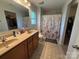Functional bathroom showcasing double sinks, tile floors, and a shower/tub combination with neutral decor at 1110 Valley St, Statesville, NC 28677