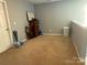 Unfurnished bonus room featuring neutral carpeting, a storage chest, and a door to another room at 1110 Valley St, Statesville, NC 28677