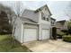 Side view of a two-story home with a two-car garage and well-maintained lawn at 1110 Valley St, Statesville, NC 28677