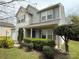 Well-maintained two-story home with a cozy front porch and manicured shrubs at 1110 Valley St, Statesville, NC 28677