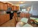 Traditional kitchen featuring wood cabinets, granite countertops, stainless steel appliances, and an adjacent breakfast nook at 1110 Valley St, Statesville, NC 28677