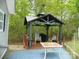 Outdoor gazebo on a patio with outdoor seating at 124 Hummingbird Cir, New London, NC 28127