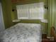 Bedroom showcasing a comfortable bed and natural light, perfect for relaxation at 124 Hummingbird Cir, New London, NC 28127