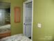 Bedroom with mirrored closet, a wall mounted TV and in unit washer and dryer at 124 Hummingbird Cir, New London, NC 28127